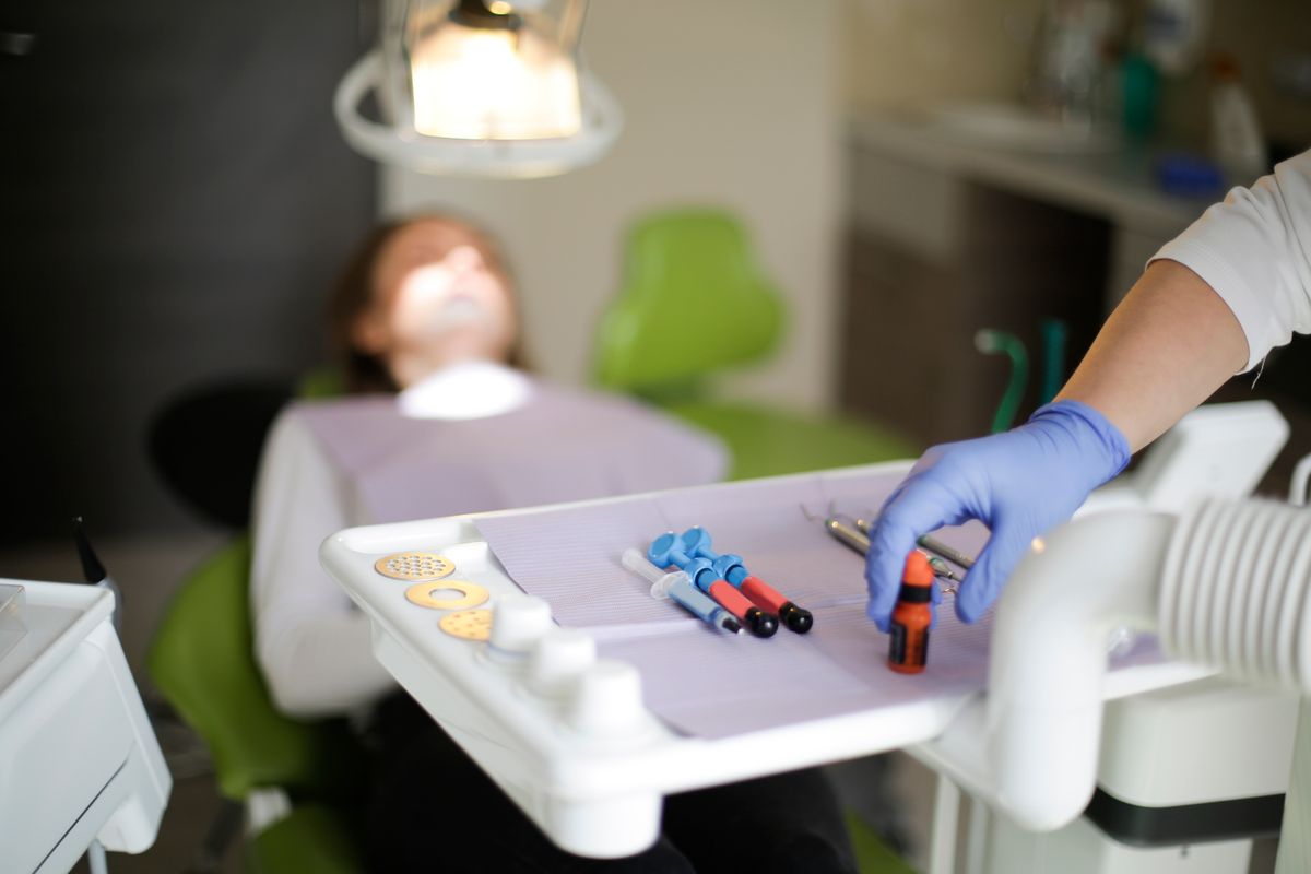 Dentist and hygienist caring for a relaxed patient (sample photo)