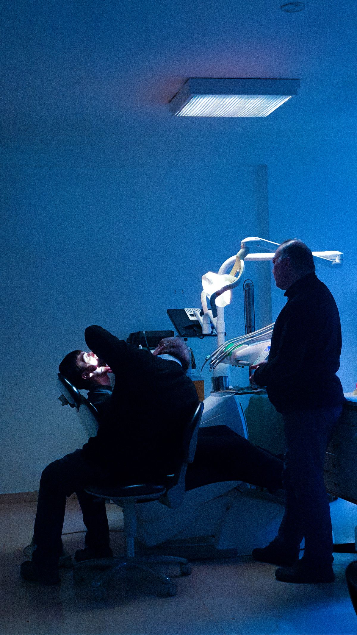 Team reviewing digital dental X-ray with patient (sample photo)